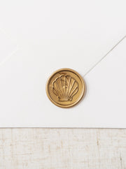 Beautiful gold wax seals featuring a line drawing of a sea shell